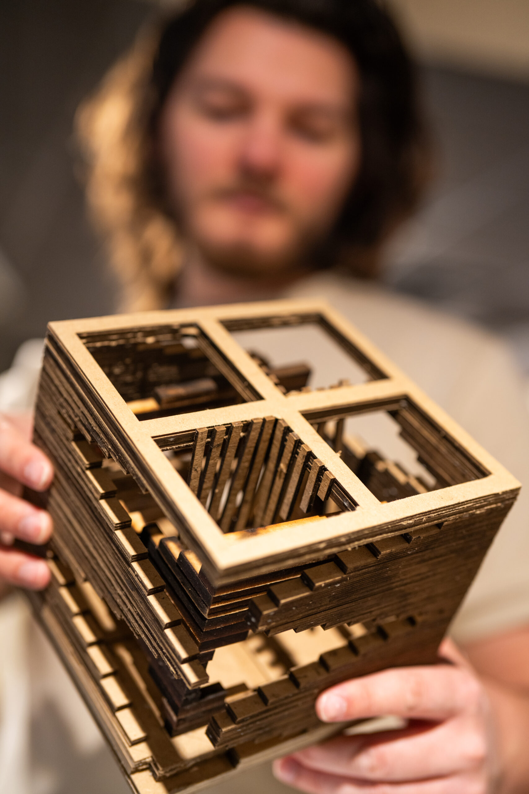 Architecture student presenting a project model.